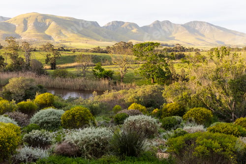 Preview: View across a tranquil landscape, river valley and a mountain range