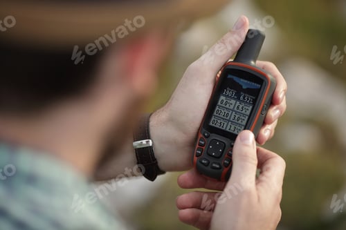 Preview: The man is holding his GPS device in his hand