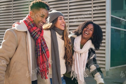 Preview: Three happy students laughing together during winter break