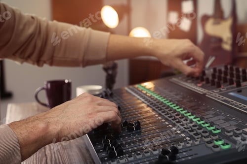 Preview: Man working with professional mixing console in modern radio studio, closeup
