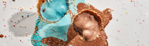 Preview: top view of delicious melted chocolate and blue ice cream in waffle cones on marble grey background