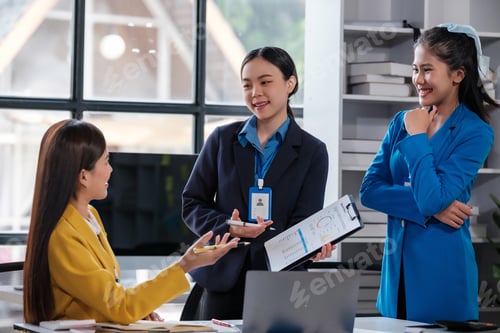 Preview: Group of Asian business people working together as a teamwork while sitting at the office desk
