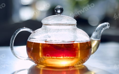 Preview: A transparent glass teapot filled with freshly brewed tea. A warm drink to heat up this winter. A n