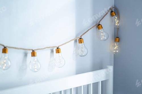 Preview: Fairy bulb lights against a blue wall.
