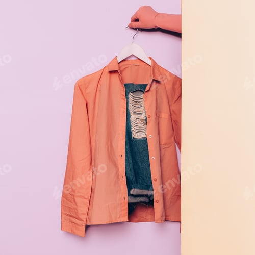 Preview: Stylish clothes. Hipster fashion. Pink shirt and jeans on a hang