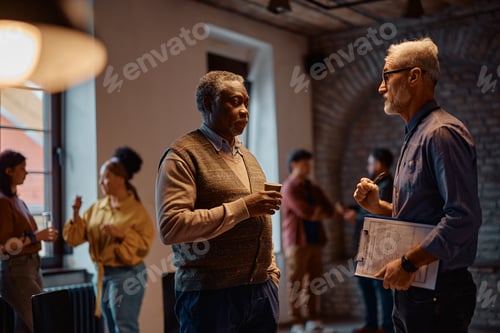 Preview: Black senior man talking to psychotherapist after group therapy at mental health center.