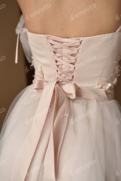 Preview: Portrait of a young beautiful bride in full growth. Girl posing in a room near the window.