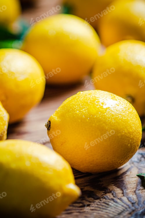 Preview: Fresh lemons. On wooden table.