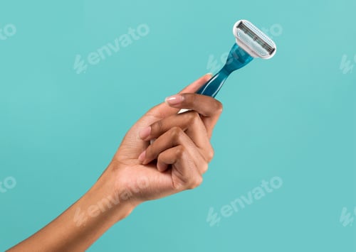 Preview: Female hand showing disposable razor