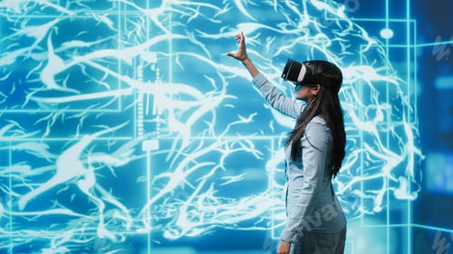 Preview: Developer wearing VR headset looking at artificial intelligence hologram