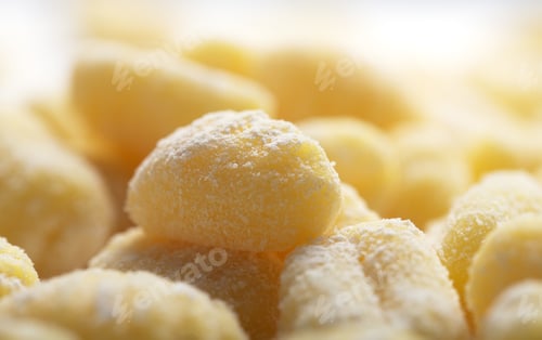Preview: Raw italian gnocchi on a white background, close up