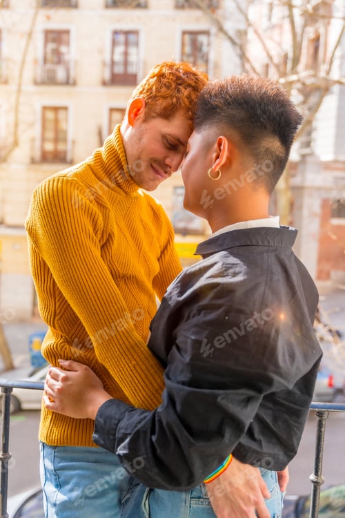 Preview: Beautiful gay couple being romantic at home on sofa, home balcony, lgbt concept