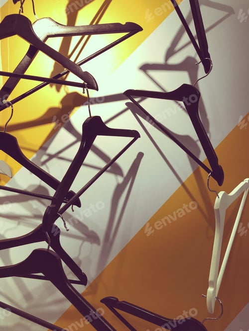 Preview: Empty clothes hangers. Chic store display.