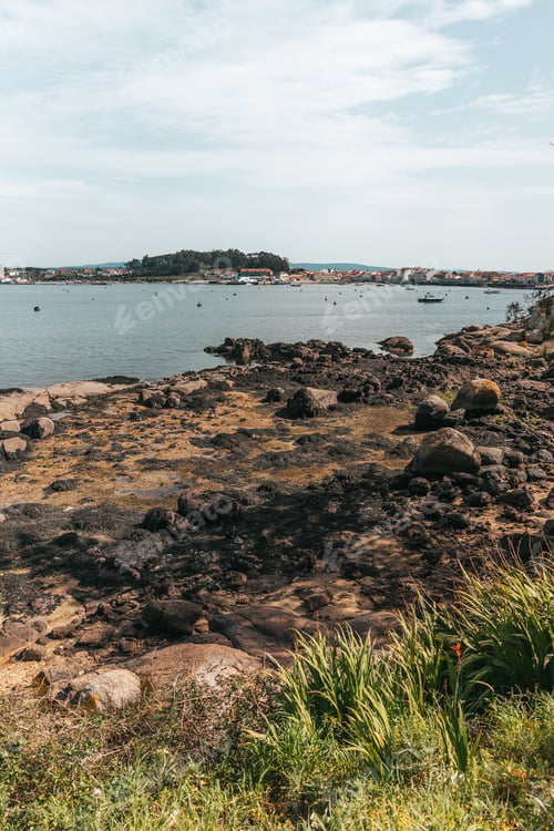 Preview: Rocky shore with small fishing boats