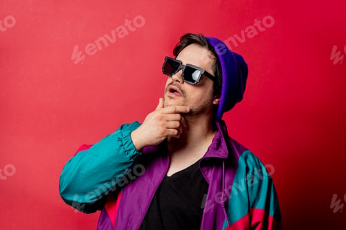 Preview: Funny guy in 80s style jacket and sunglasses on red backgorund