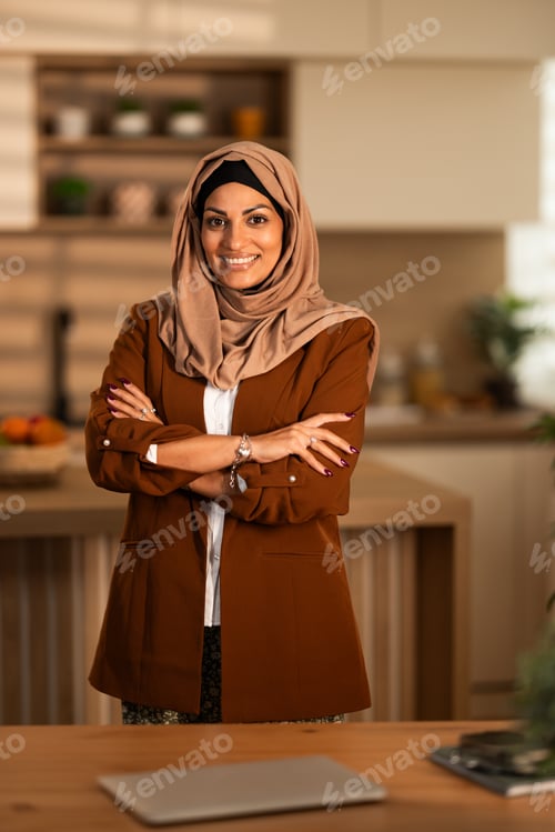 Preview: Confident Hijab-Wearing Woman In Brown Jacket Stands With Arms Crossed