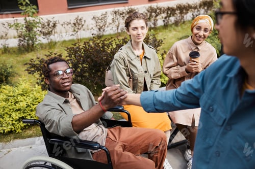 Preview: Making handshake with man in wheelchair