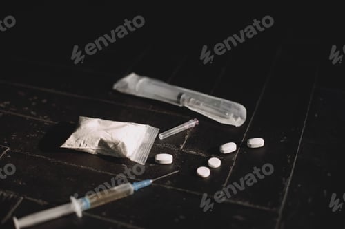 Preview: Syringe and pills on dark background close up