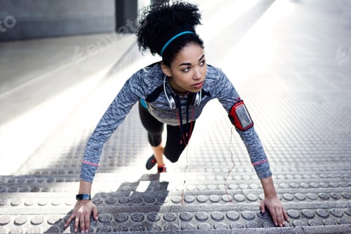 Preview: Fit and sporty young woman doing stretching in city.