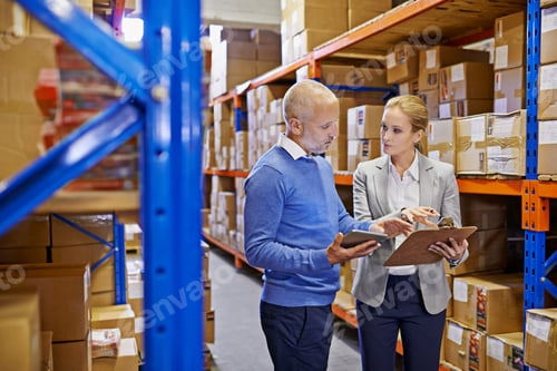 Preview: Shot of a man and woman inspecting inventory in a large distribution warehouse