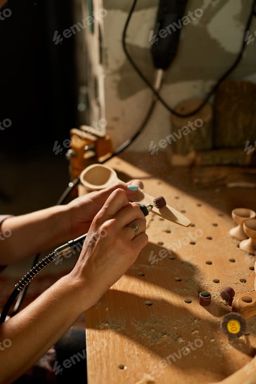 Preview: Female using power working tools graver for wooden utensils spoon