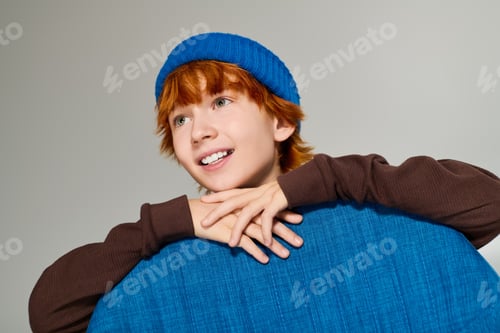 Preview: Bright smiles from a stylish redhead boy in a modern studio setting