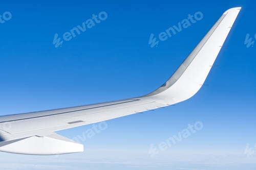 Preview: Wing aircraft in altitude during flight. clear sky in sunny day.