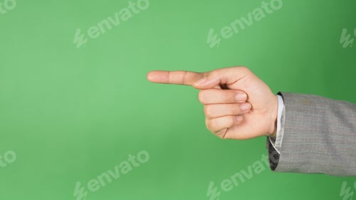 Preview: a hand in a gray suit and pointing with the index finger on green screen background.