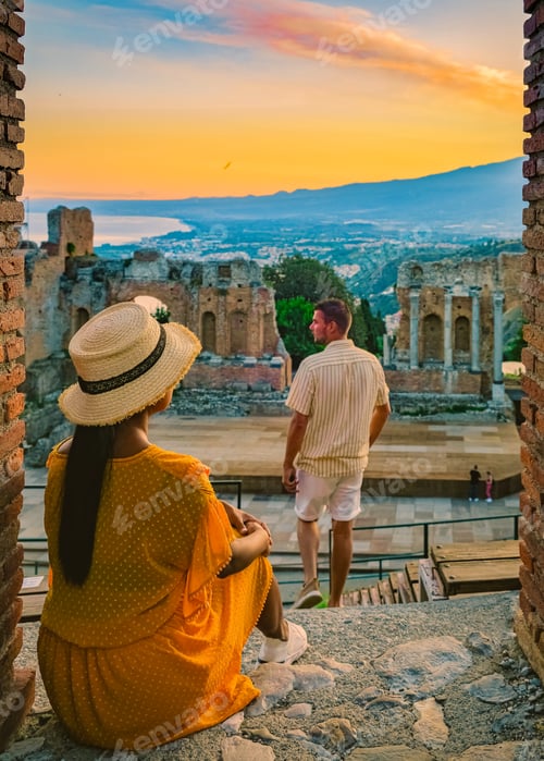 Preview: Taormina Sicily, couple watching sunset at the Ruins of the Ancient Greek Theater Taormina, Sicily
