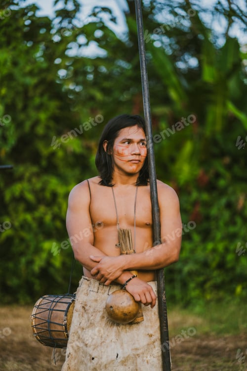 Preview: Tribal man with stick in tropical forest