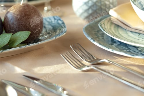 Preview: Silver cutlery on table top with tablecloth