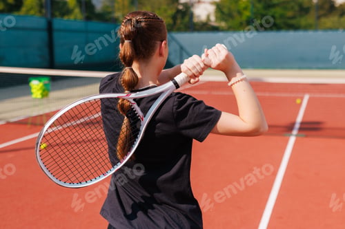 Preview: Young Woman Tennis Player Preparing to Serve on Outdoor Court During Training Session
