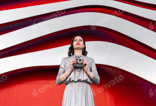 Preview: Beautiful woman by the red wall
