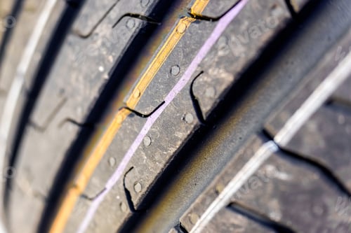 Preview: Detail of the grooves of a new car tire.