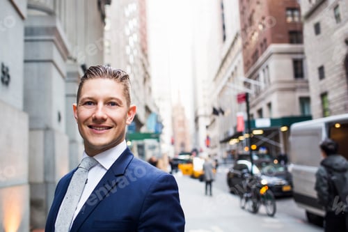Preview: Confident businessman smiling on a bustling city street.