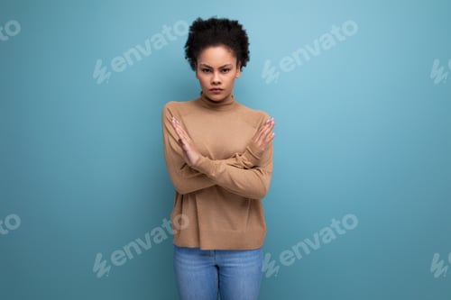 Preview: positive young authentic latino woman with afro hair tied up in a ponytail against the background