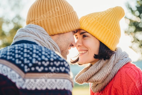 Preview: Adorable brunette female and her boyfriend stand closely to each other, look at eyes
