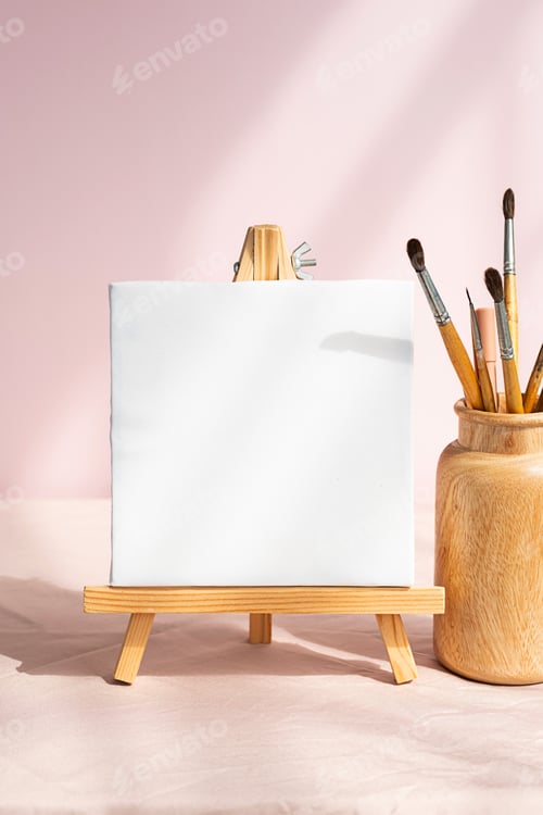 Preview: Blank white canvas and vase with paintbrushes for art. Artistic layout.