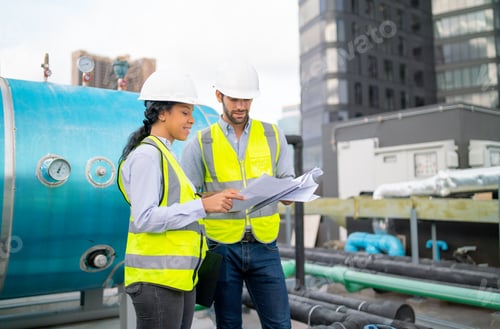 Preview: Couple professional engineer or technician workers discuss with blue print of construction site