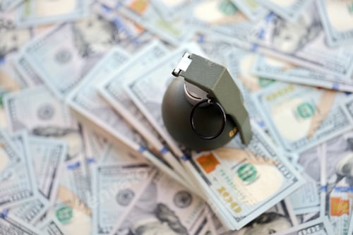 Preview: Grenade with a check against the background of huge amount of american dollar bills