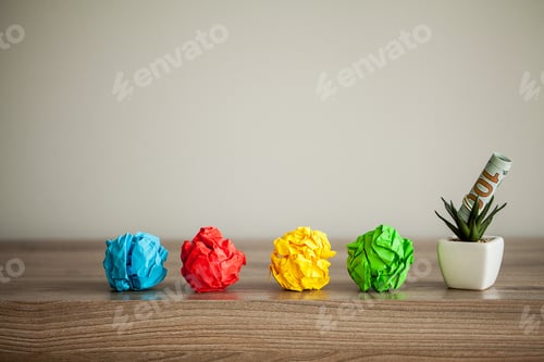 Preview: Great idea concept. Crumpled colorful paper on wooden table