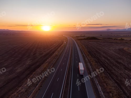Preview: Aerial view of highway road at sunset in autumn. Top view from drone of road