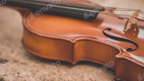 Preview: A viola on an off-white marble table. Focus on the sound hole (f-hole).