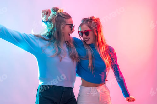 Preview: Females embracing in a warm hug illuminated by bright neon lights creating clubbing atmosphere