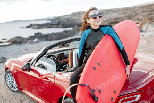 Preview: Young surfer with surfboard on the sports car on the beach