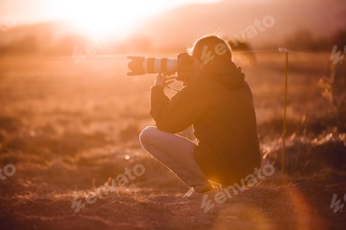 Preview: Man shooting on camera beautiful landscape between hills