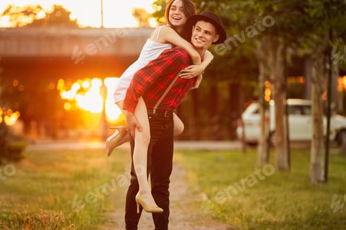 Preview: Caucasian young and happy couple enjoying a picnic in the park on summer day
