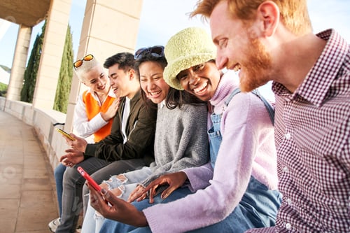 Preview: Group of young mixed race people with mobile phones. Excited students using cell. Concept of young.