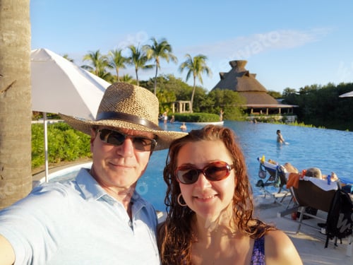 Preview: Couple Enjoying Vacation at Tropical Resort Pool