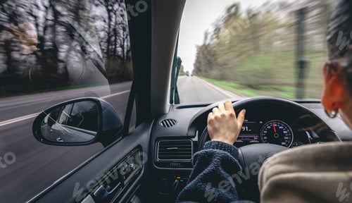 Preview: Woman driver's hands on a car steering wheel.
